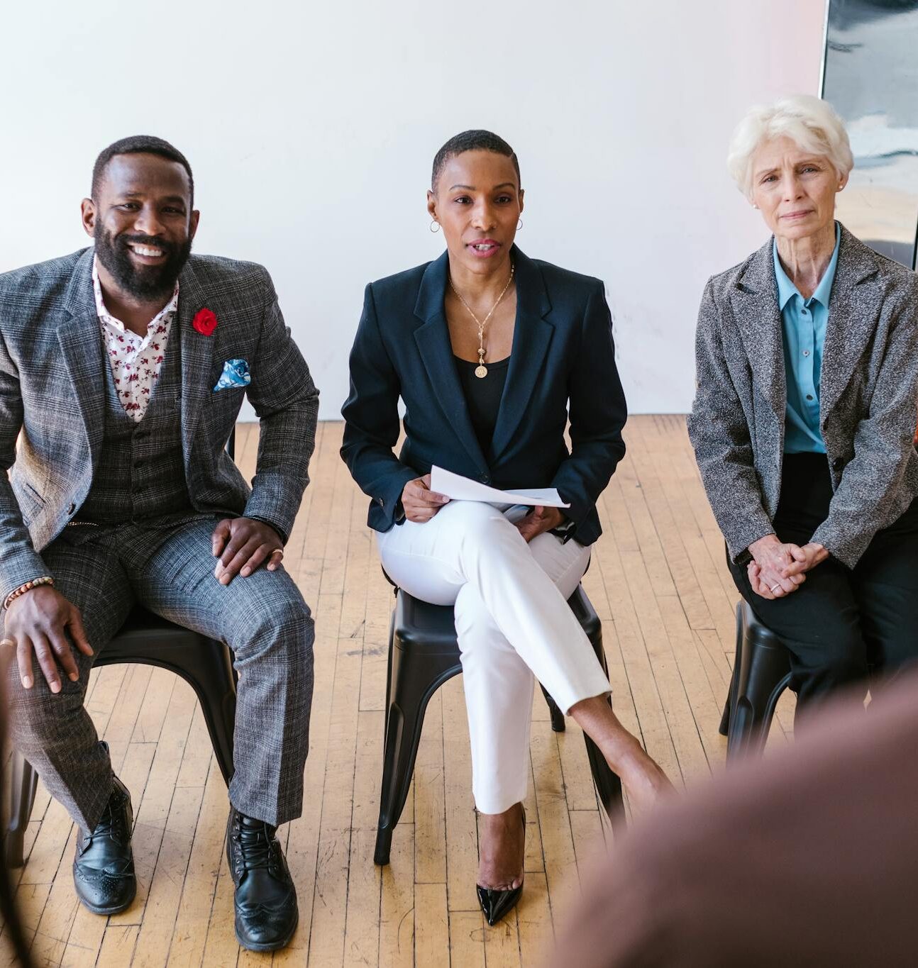 A diverse group of professionals in a meeting, attentively listening and engaged.